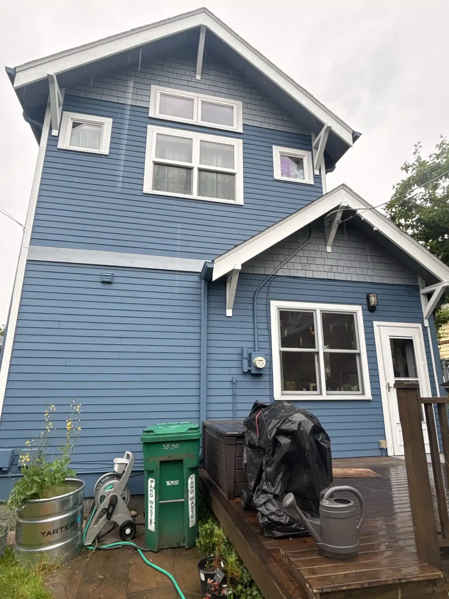 Blue Residential Home Exterior Blue-painted two-story residential home with white-trimmed windows, garage, and covered entry porch in Seattle, WA